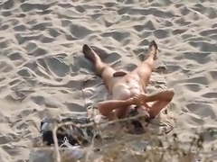 Nudist touching himself on the beach